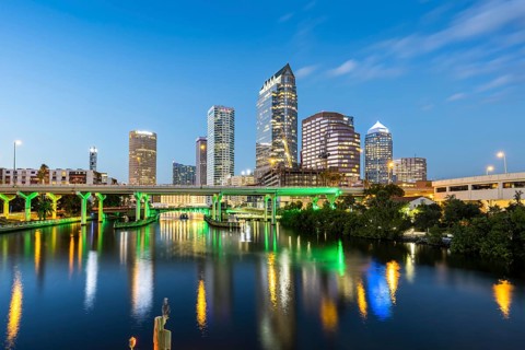 Tampa skyline with skyscrapers and bridge over Hillsborough River at night in downtown Tampa, USA
