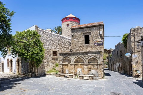 Ottoman fountain and windmill in the historic old town from the Middle Ages on the island of