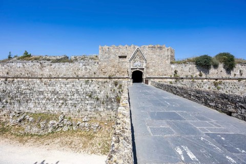 Red gate from the Middle Ages in the city wall of the historic old town on the island of Rhodes,