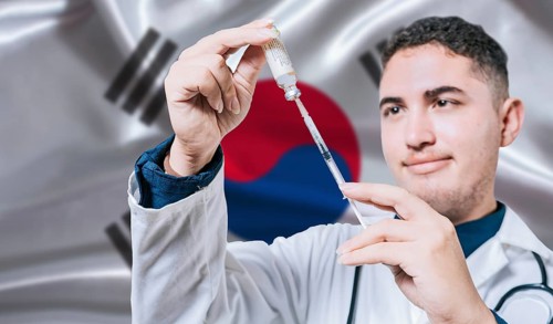 Doctor holding syringe on South Korea flag background. Medical professional holding syringe with