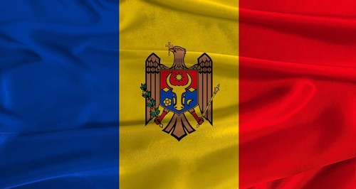 Flag of Moldova with fabric textured background. Close up of National flag of Moldova with