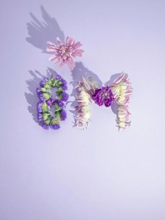 Flowers forming the 8m symbol on a purple background representing international women's day