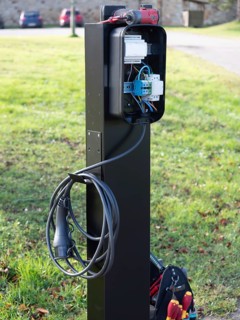 Electric vehicle charging station showing internal wiring during installation process