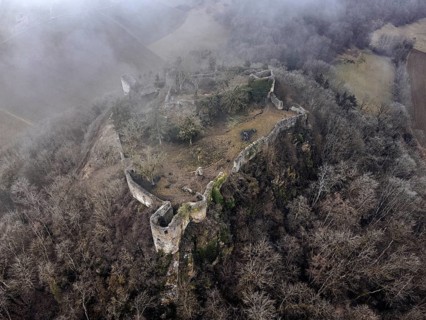 Aerial view of the ruins of Mägdeberg Castle in Hegau on a foggy winter day, Mühlhausen-Ehingen,
