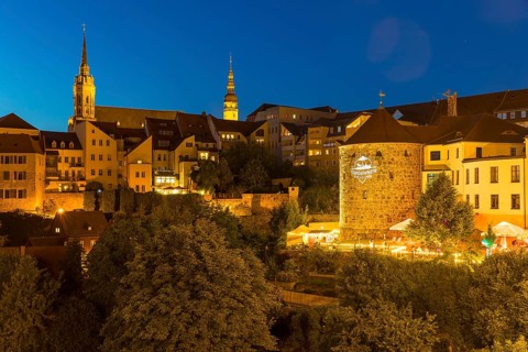 City view at night with St. Petri Cathedral, Town Hall Tower and Röhrscheidtbastei with beer