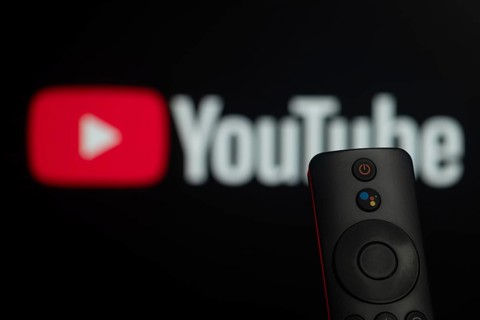 Dhaka, Bangladesh- 21 Jan 2026: Close-up of a smart TV remote control against a blurred youtube