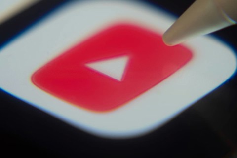 Dhaka, Bangladesh- 06 Dec 2025: Close-up of the youtube app on a screen with a stylus pointing at