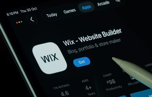 Dhaka, Bangladesh- 30 Oct 2025: Wix app displayed on a iPad screen in dark mode with a digital pen