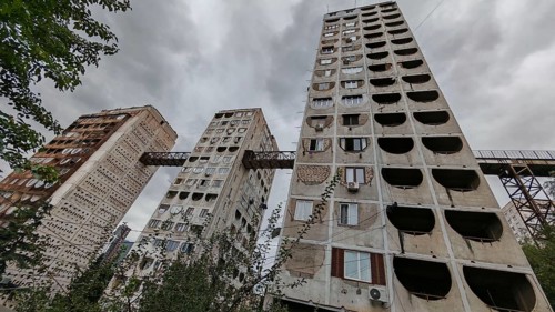Three high-rise buildings connected by metal bridges under cloudy skies, nostalgic charm,