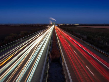 Night shot, long exposure, light trails on the A38 motorway, Schkopau power plant in the back,