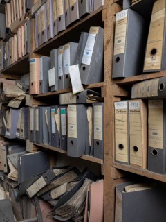 Shelves with dusty folders in the administration of a former GDR factory, Lost Place,