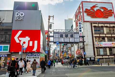 Lots of colorful signs in a pedestrian zone with shops and restaurants, Dotonbori, Osaka, Japan