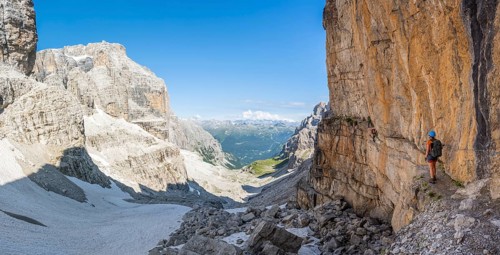 Mountaineers on the Bocchette Centrale band trail, via ferrata in the Brenta Mountains, rock wall,