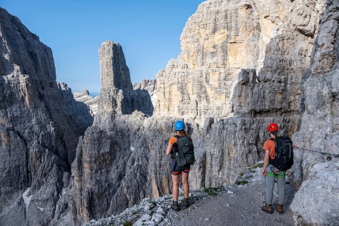 Mountaineers look at Campanile Alto pinnacle, Bocchette Centrale band trail, via ferrata in the