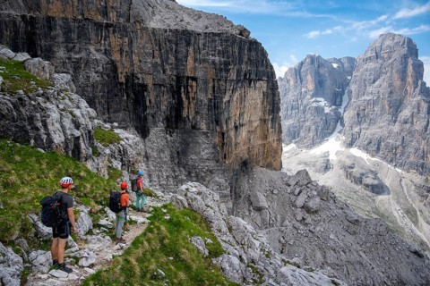 Three mountaineers on a hiking trail, rocky mountain landscape, Via Ferrata SOSAT via ferrata,