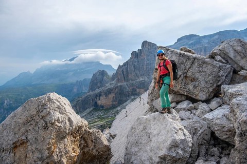 Female mountaineer on a hiking trail, rocky mountain landscape, Via Ferrata SOSAT via ferrata,