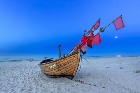 Traditional wooden fishing boat on the beach along the Baltic Sea at Stubbenfelde, Loddin on the