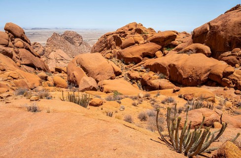 Sublime rock formations in the vast desert landscape of Spitzkoppe with isolated vegetation,