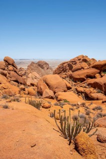 Rocky landscape under bright blue sky in Spitzkoppe, with some vegetation, Spitzkoppe, Erongo,