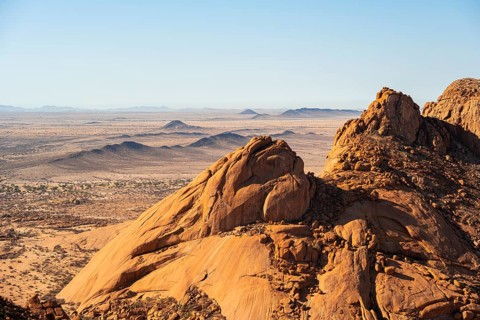 Mountain massif in the dry expanse of the desert under clear skies, Spitzkoppe, Namibia