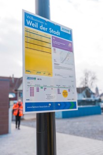 An informative sign on the platform with city and timetable information, opening of the Hermann