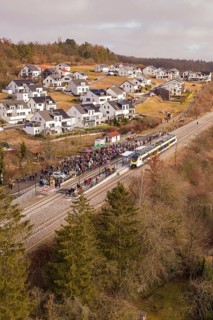 A train crosses a small village surrounded by forest and winter atmosphere, opening of the Hermann