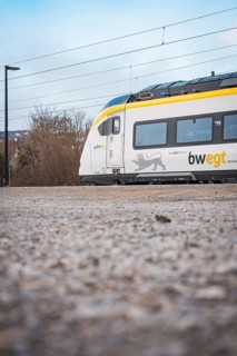 Side view of a modern train surrounded by a wintry atmosphere, opening of the Hermann Hesse