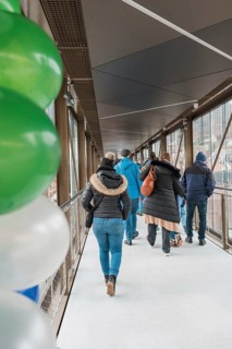 People on a covered bridge with colorful balloons, opening of the Hermann Hesse Railway, Calw,