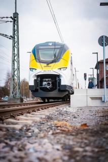 Modern locomotive at close range on railway tracks under grey skies, opening of the Hermann Hesse