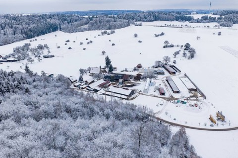 Farmhouse in a vast, snowy winter landscape with forests and fields, Haselstaller Hof, Gechingen,