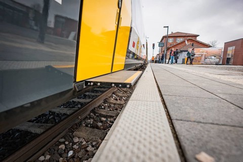 Close-up of a yellow train on the tracks of a train station, Siemens Micro Plus B battery electric
