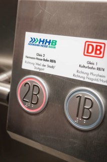 Close-up of track number plates and buttons in a train station, battery electric train Siemens