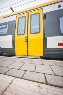 Close-up of a yellow train door on a platform, Siemens Micro Plus B battery electric train,