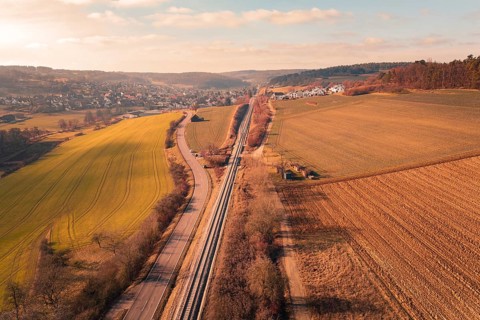 Aerial view of a rural area with fields, village and parallel traffic routes, fire drill on the
