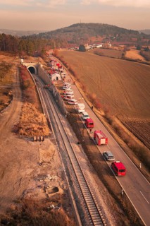 Aerial view of a scenario with emergency vehicles along a tunnel and a road, fire drill at the