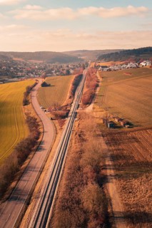 Aerial view of a rural area with railroad, road and village in the background, fire drill on the