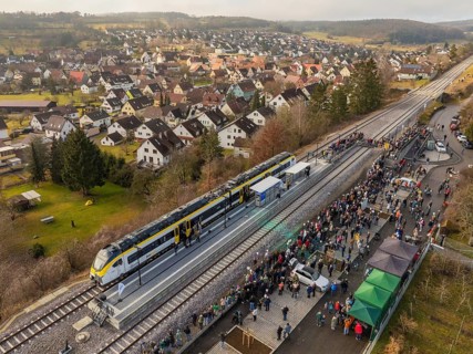 Village event on the arrival of a train, people gather at the platform, opening of the Hermann