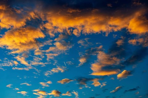 Aircraft contrails with red clouds, sunrise, Upper Austria