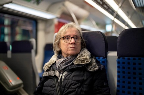 Elderly woman, portrait, thoughtful, glasses, gray hair, coat, scarf, winter clothes, sitting in