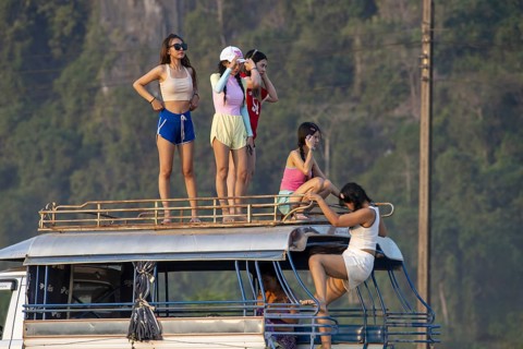 Photo shoot with young girls in the karst landscape near Vang Vieng, Vientiane province, Laos