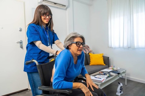 Caregiver pushing an elderly woman in a wheelchair, providing support and companionship, preparing