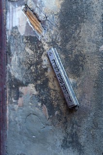 A mezuzah at an entrance to a Jewish house means door post and describes a font capsule on a door