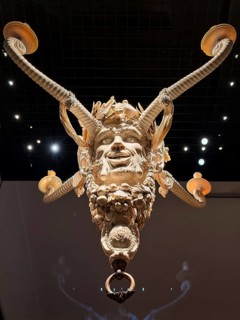 Ivory candle holder with intricate carving of a face, ivory collection, Bavarian National Museum,
