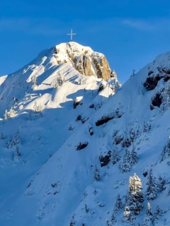 Snow-covered summit of Branderschrofen with summit cross, Tegelberg in winter, Schwangau, Allgäu