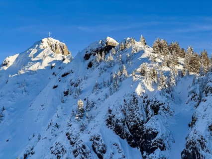Snow-covered summit of Branderschrofen with summit cross, Tegelberg in winter, Schwangau, Allgäu