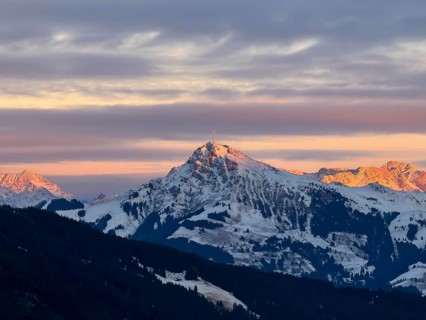 Alpine glow at sunset, Kitzbühler Horn mountain peak in winter, Brixental, Kitzbühel Alps, Tyrol,