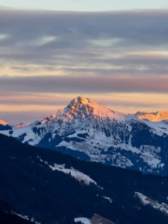 Alpine glow at sunset, Kitzbühler Horn mountain peak in winter, Brixental, Kitzbühel Alps, Tyrol,
