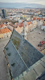 Bird's eye view of a town church with a distinctive tower and surrounding square, Pilsen, Czech