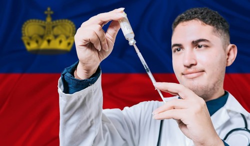 Doctor holding syringe on Liechtenstein flag background. Medical professional holding syringe with