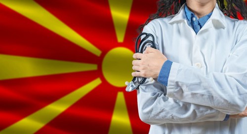 Healthcare professional with North Macedonia flag background. Professional doctor holding